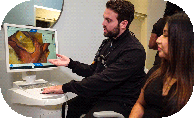 Dentist reviewing digital 3D dental scans with a patient during a consultation at O2 Dental Group.