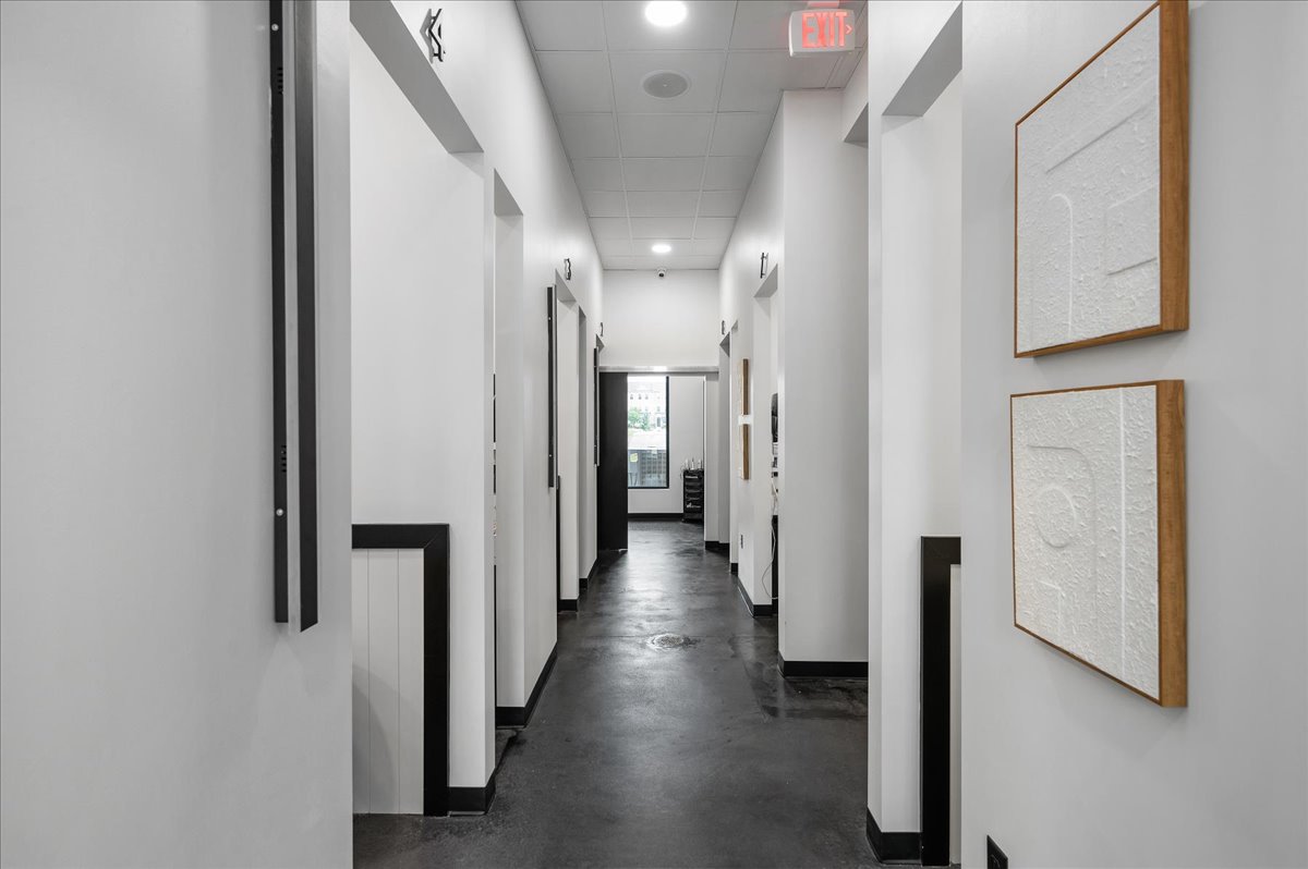Modern hallway leading to private treatment rooms at O2 Dental Group Raleigh